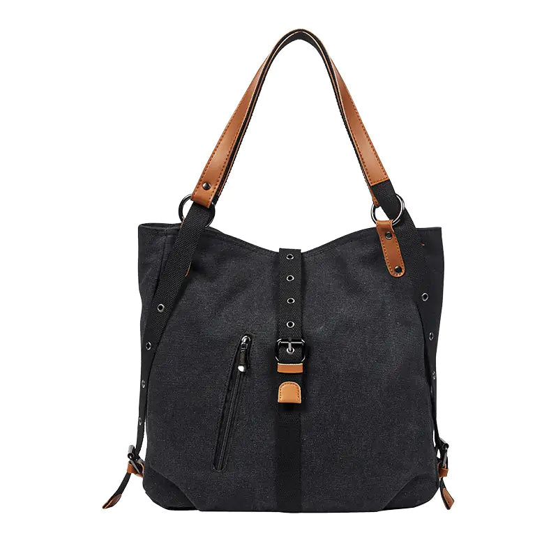 Black tote bag with brown straps on a white background