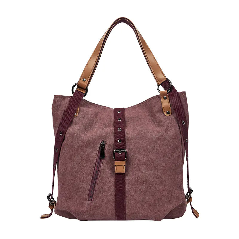Brown handbag with leather straps on a white background