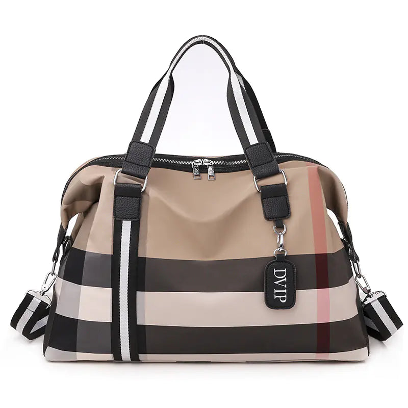 Beige and brown checkered handbag with black straps on a white background
