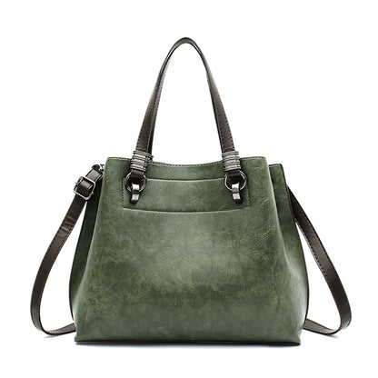 Green handbag with brown straps on a white background