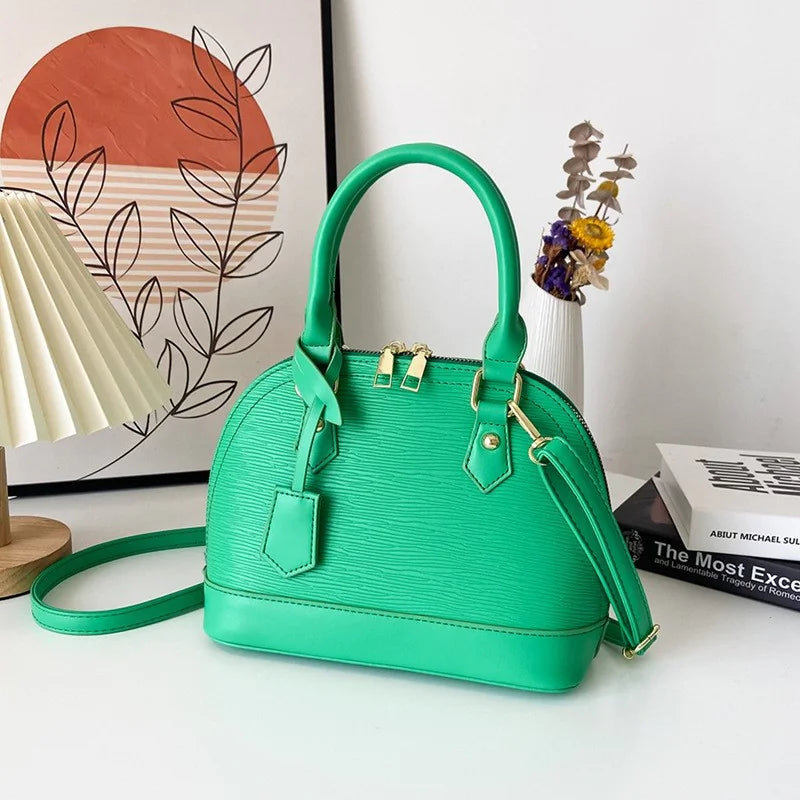 Green handbag on a white surface with a decorative background