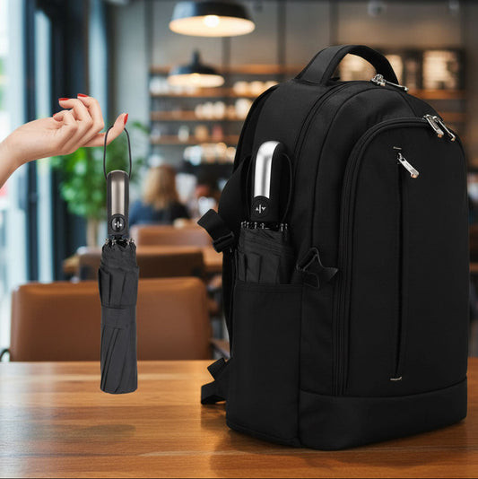 Black backpack with umbrella attachment on a table in a cafe setting
