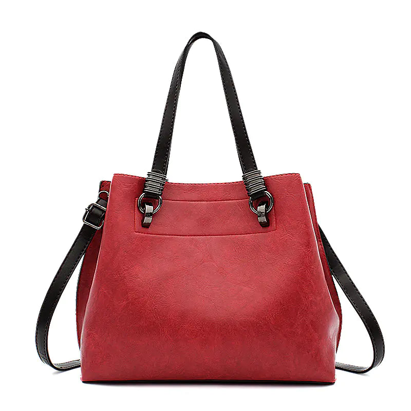 Red handbag with black straps on a white background