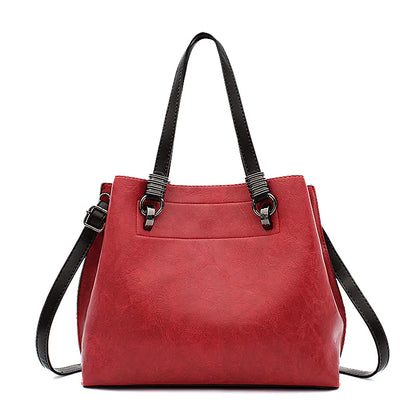 Red handbag with black straps on a white background