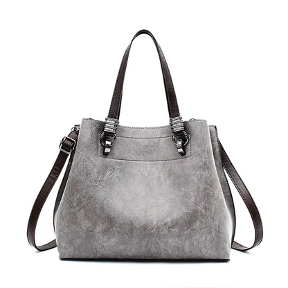 Gray handbag with brown straps on a white background