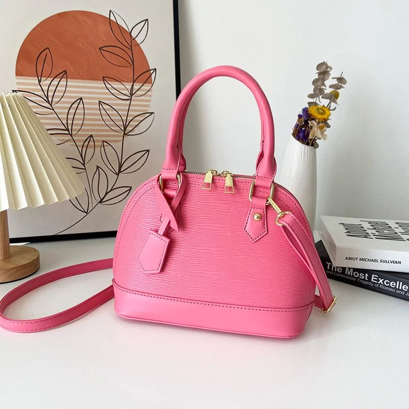 Pink handbag on a white surface with a decorative background